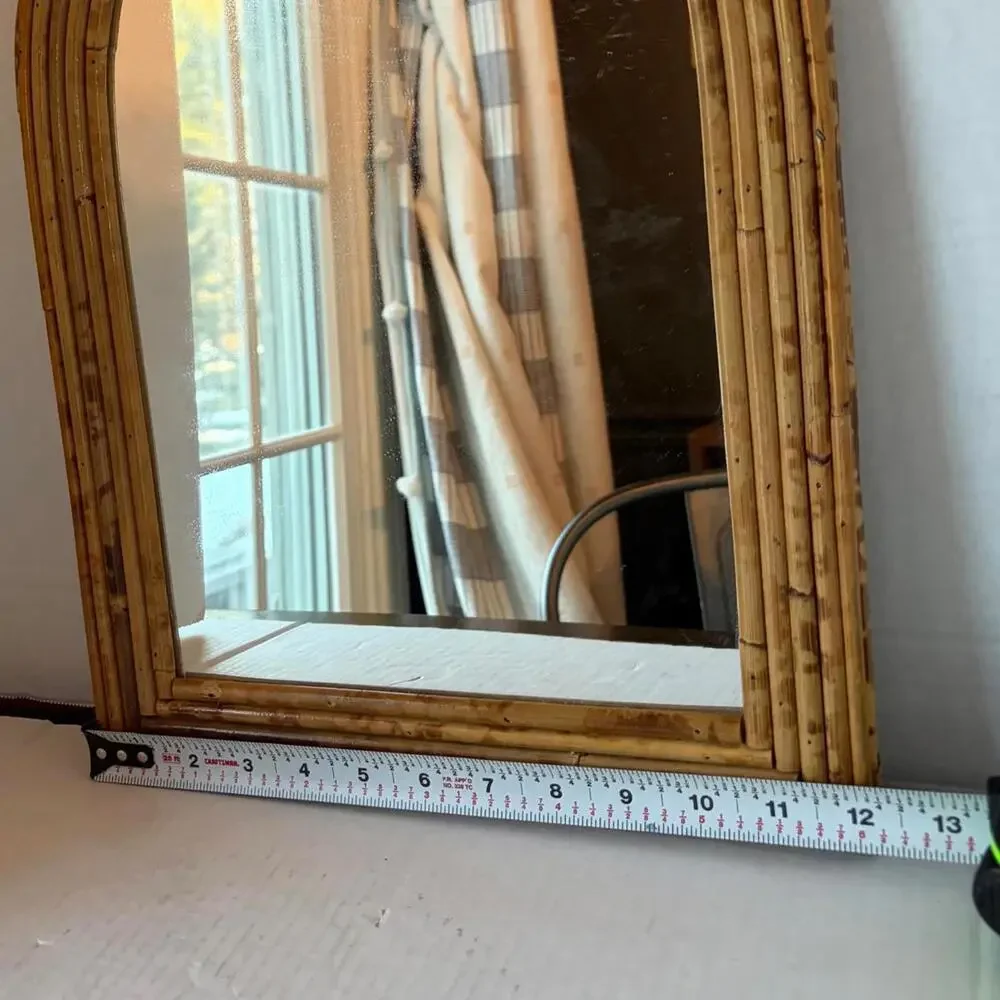 Vintage Arched rattan mirror with a natural, aged finish.